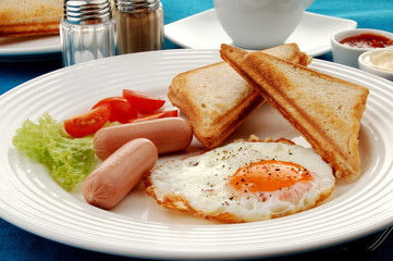 Breakfast - toasts, egg, sausage and vegetables