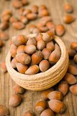 Pot full of hazelnuts on wooden surface