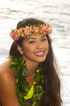 hawaiian girl with flowers on lava cliffs by the ocean