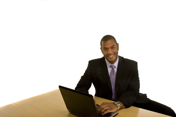 Black Man Working on Laptop Smiling at Camera