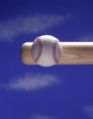 a baseball bat hitting a baseball