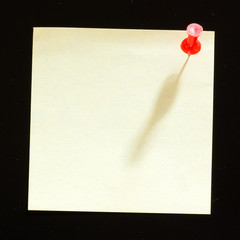 Yellow sticker note isolated on the black background