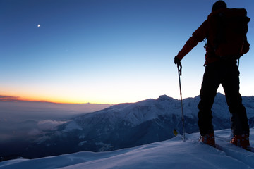 backcountry skier reaching the summit of the mountain