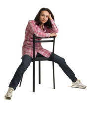 Fototapeta premium Woman sits on a chair back to front.