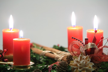Advent wreath with four orange candles closeup