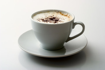 Ceramic mug with a cappuccino on light  background