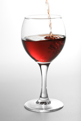 red wine pouring into glass
