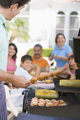Fototapeta na wymiar Family Enjoying A Barbeque