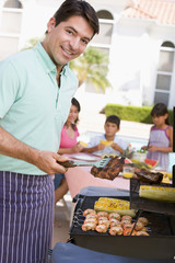 Family Enjoying A Barbeque