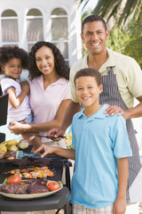 Family Enjoying A Barbeque