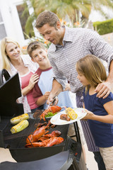 Family Enjoying A Barbeque