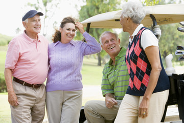 Portrait Of Four Friends Enjoying A Game Golf
