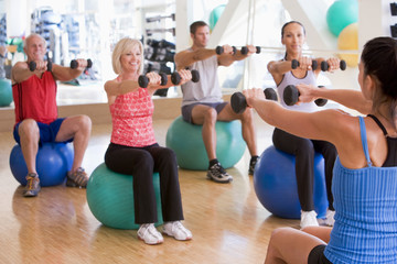 Instructor Taking Exercise Class At Gym - Powered by Adobe