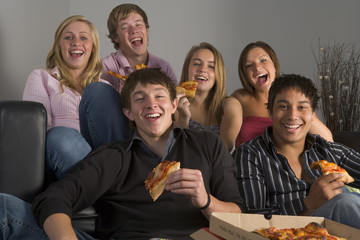 Teenagers Having Fun And Eating Pizza