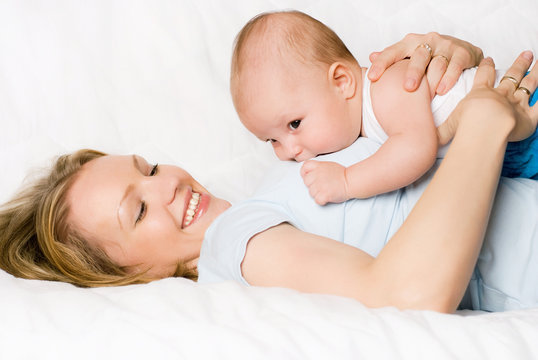 happy mother with her son on the bed