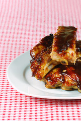 cut up barbecue spare ribs on a plate