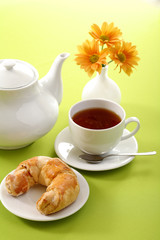 Breakfast concept with coffee and croissant