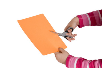 Child hands cutting an orange paper with a scissors