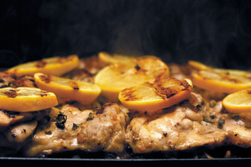 Chicken thighs on the Grill topped with lemons