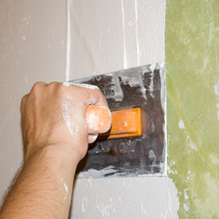 closeup of man's hand holding a trowel