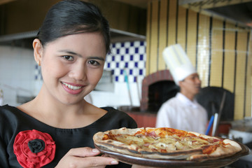 Waitress and chef at pizza restaurant