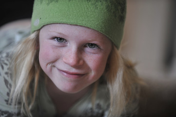 Little girl in a green wool cap.