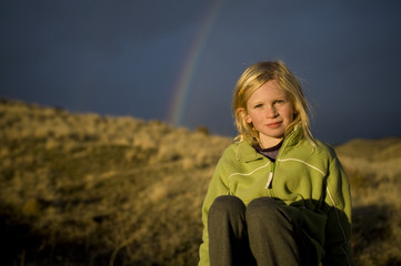 Girl beneath a rainbow