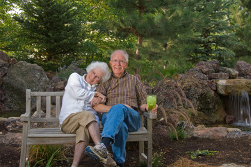 Elderly man and woman sitting on a bench