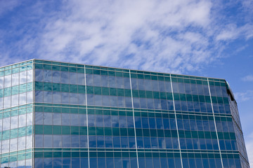 Sky and Clouds on Green Striped Building