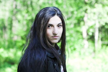 Naklejka premium Young woman in summer park