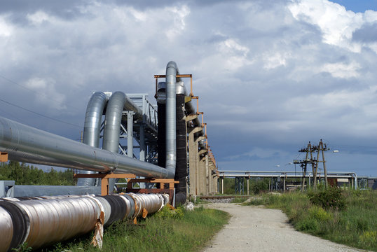 industrial pipelines on pipe-bridge against blue sky