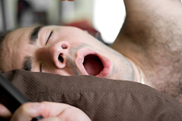 Man Yawning In Bed