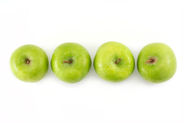 Four green apples in a row