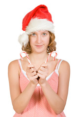 Girl in a santa clause cap with  red and white candy canes