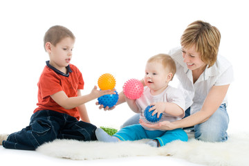 Mother with her sons enjoy with colorful balls