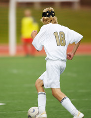 High school soccer player moving in for a goal