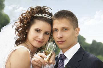 Bride and groom holding glasses with champagne