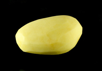 Peeled clean potato isolated on black