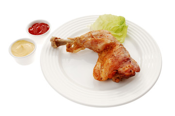 Roasted chicken leg with vegetables isolated on white