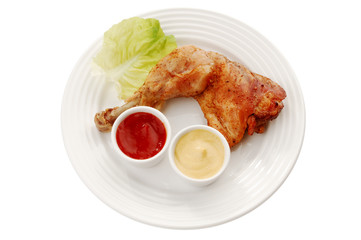 Roasted chicken leg with vegetables isolated on white