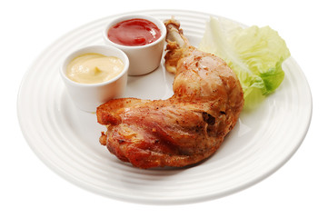 Roasted chicken leg with vegetables isolated on white