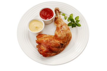 Roasted chicken leg with vegetables isolated on white