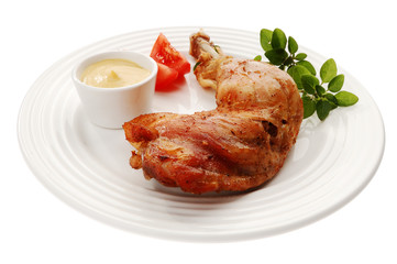 Roasted chicken leg with vegetables isolated on white
