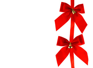 Two Big red holiday bows with bells on white background