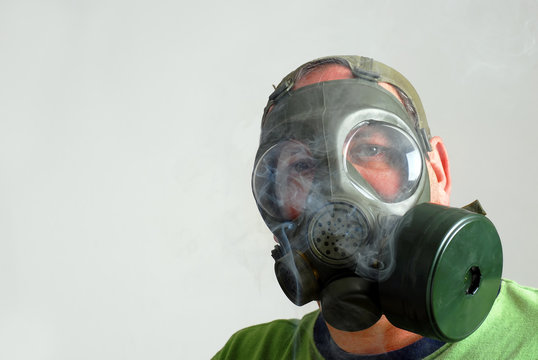 Man wearing a gas mask to avoid second hand smoke