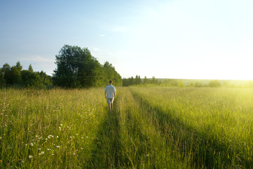 one man and field of summer grass