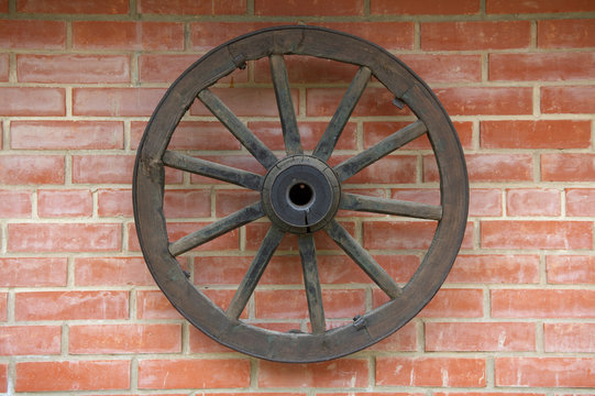 Old Wagon Wheel on brick Wall