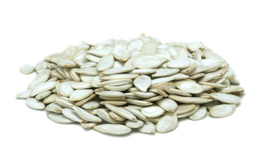 Many pumpkin sunflower seeds on a white background