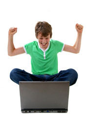Happy boy looking at laptop computer