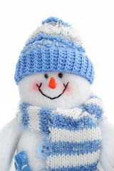 smiling snowman toy dressed in scarf and cap